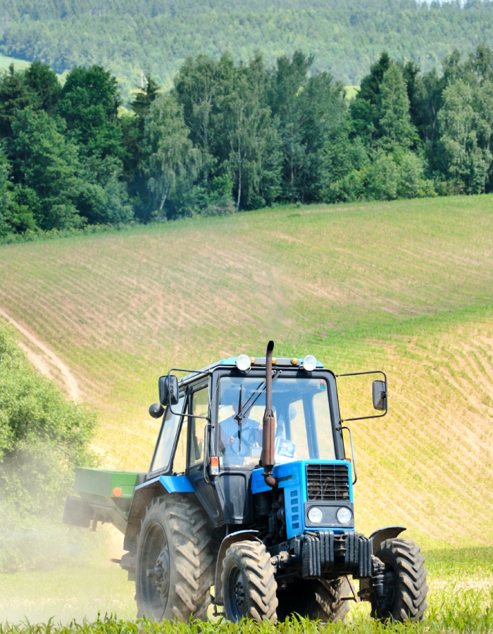 Tracteur agricole bleu en action dans un champ pour travaux agricoles